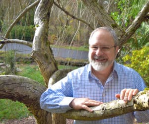 Eric Thorton the master spiritual healer, medium, author and exorcist; is posing front view while smiling
