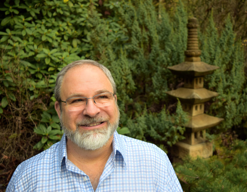 Eric Thorton the master spiritual healer, medium, author and exorcist; ponders in his Zen-style garden