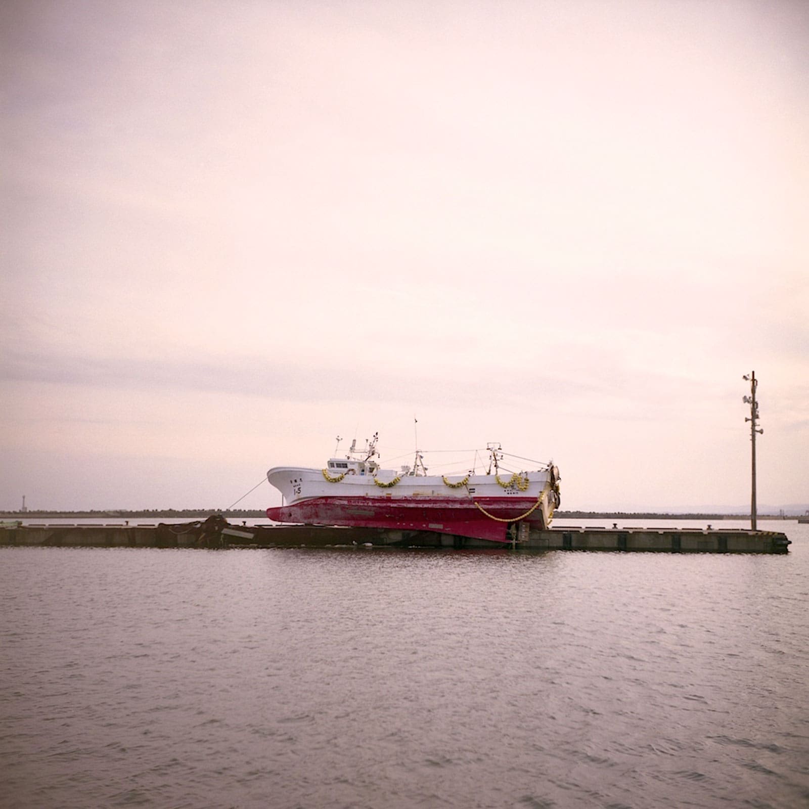 Fishing boat stranded on a pier after the Japan Tsunami of 2011