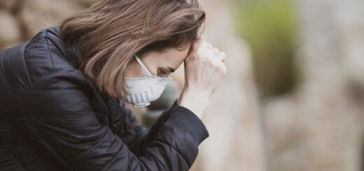 woman wearing medical mask is praying